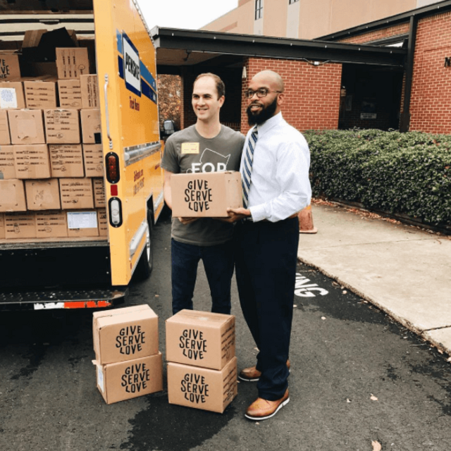 volunteer delivering snack boxes to a local school