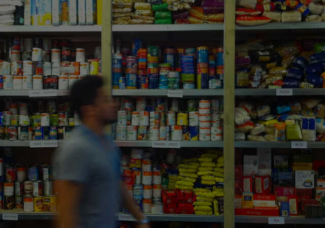 Man Walking Through Food Pantry with Dark Photo Overlay
