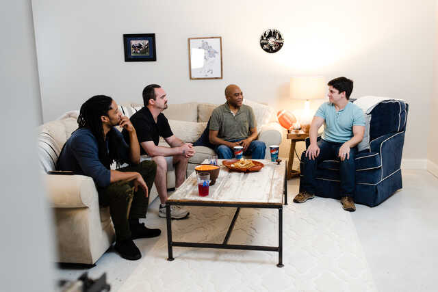 mens community group meeting in a living room