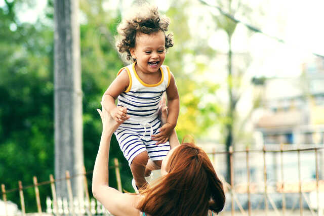 Image of women playing with child