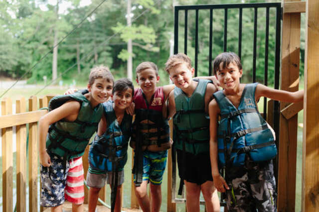 6th grade boys in lifevests at camp